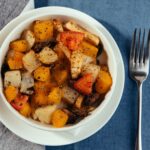 The cut fresh vegetables in a dish with spices